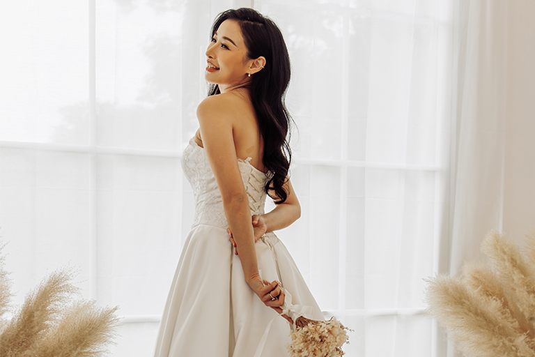 Bride standing in a white wedding dress